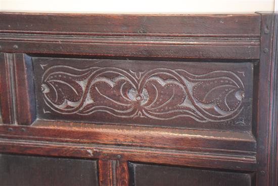 An 18th century oak settle, W.5ft 11in. D.1ft 9.5in. H.3ft 7in.